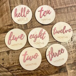Pink wooden monthly milestone photo discs